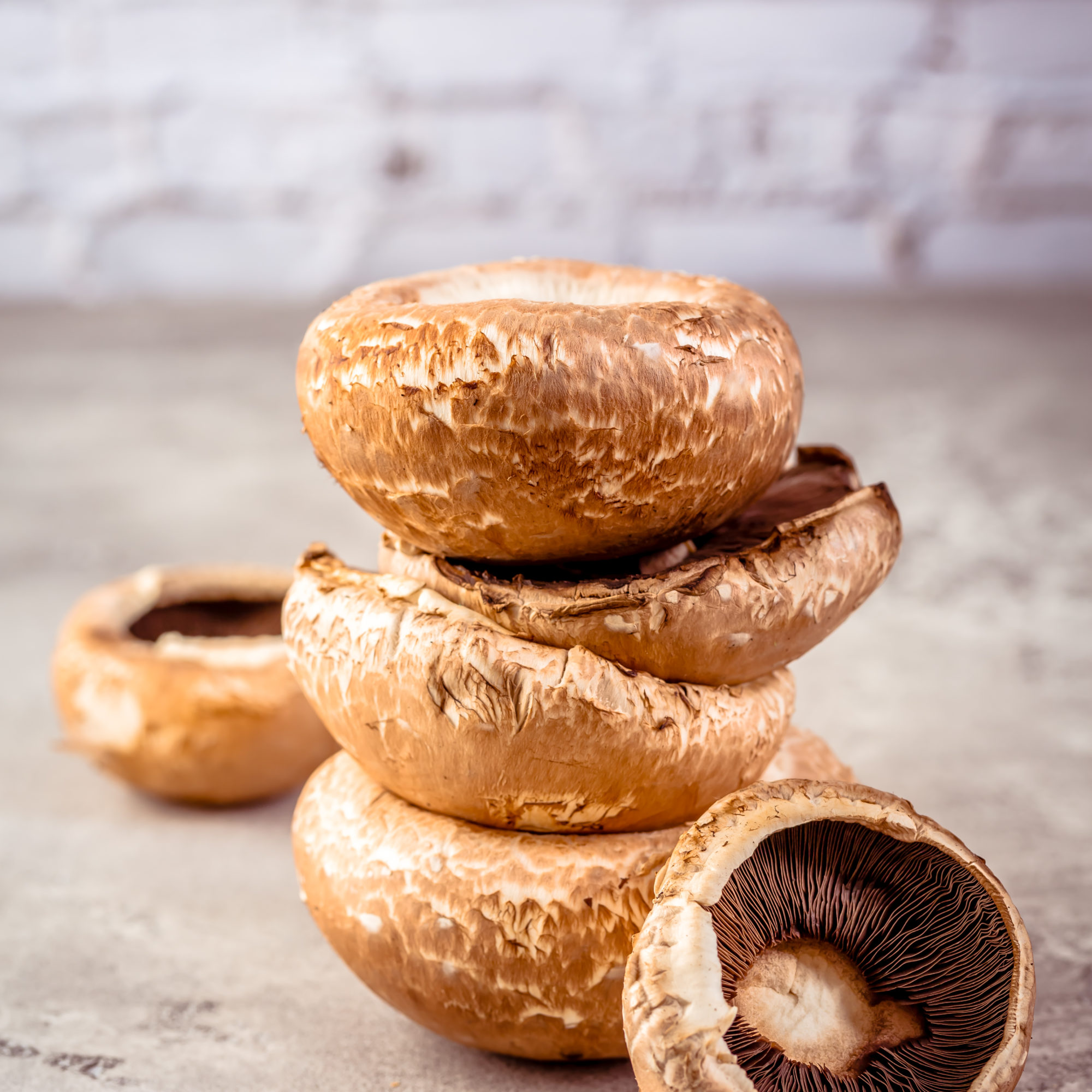 Raw portobello mushrooms on kitchen table